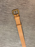 A 0.8 inch wide dress belt in camel vegan leather. Nickel free brass buckle, tan/beige lining.