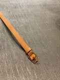 A 0.75 inch wide belt in camel vegan leather, nickel-free brass buckle.